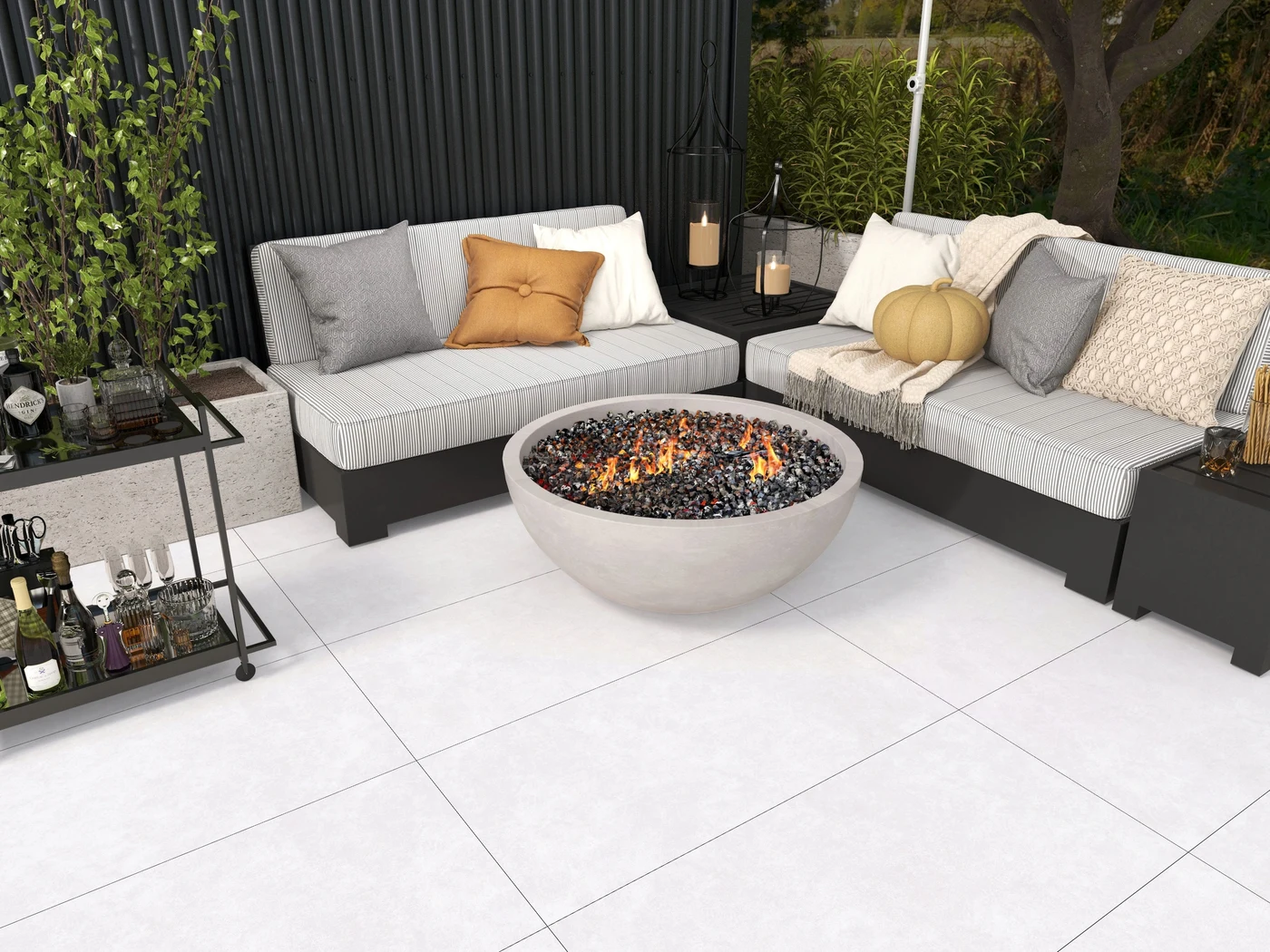 Pale tiled outdoor lounge with a central fire bowl